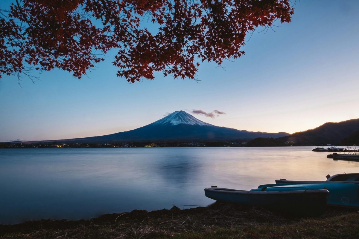 Capture the beauty of Mount Fuji with vibrant autumn leaves at Lake Kawaguchi during twilight.